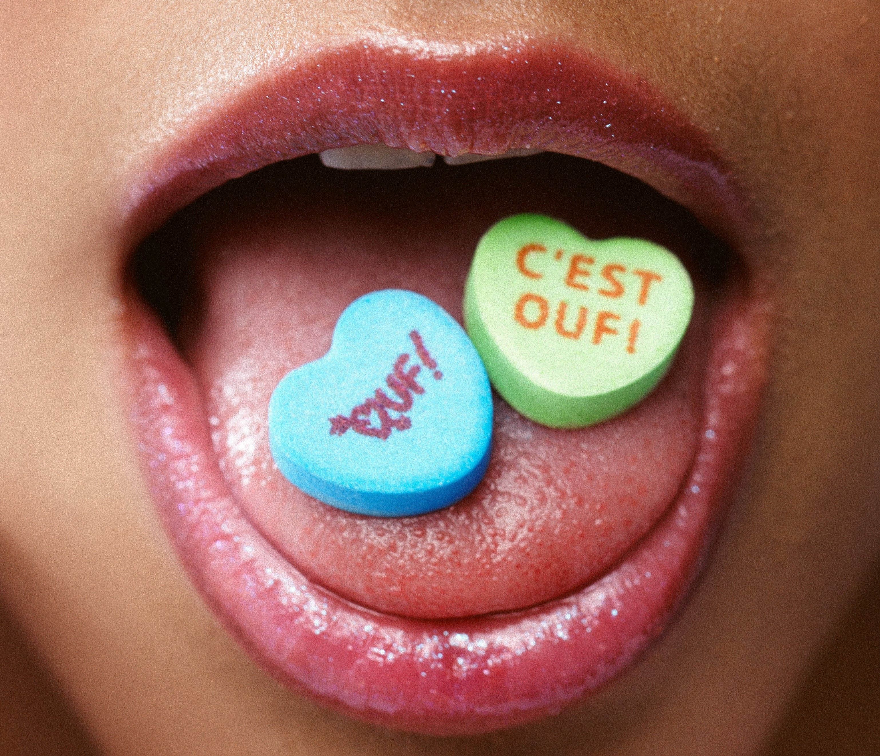 Ouf! candy conversation hearts in models open mouth